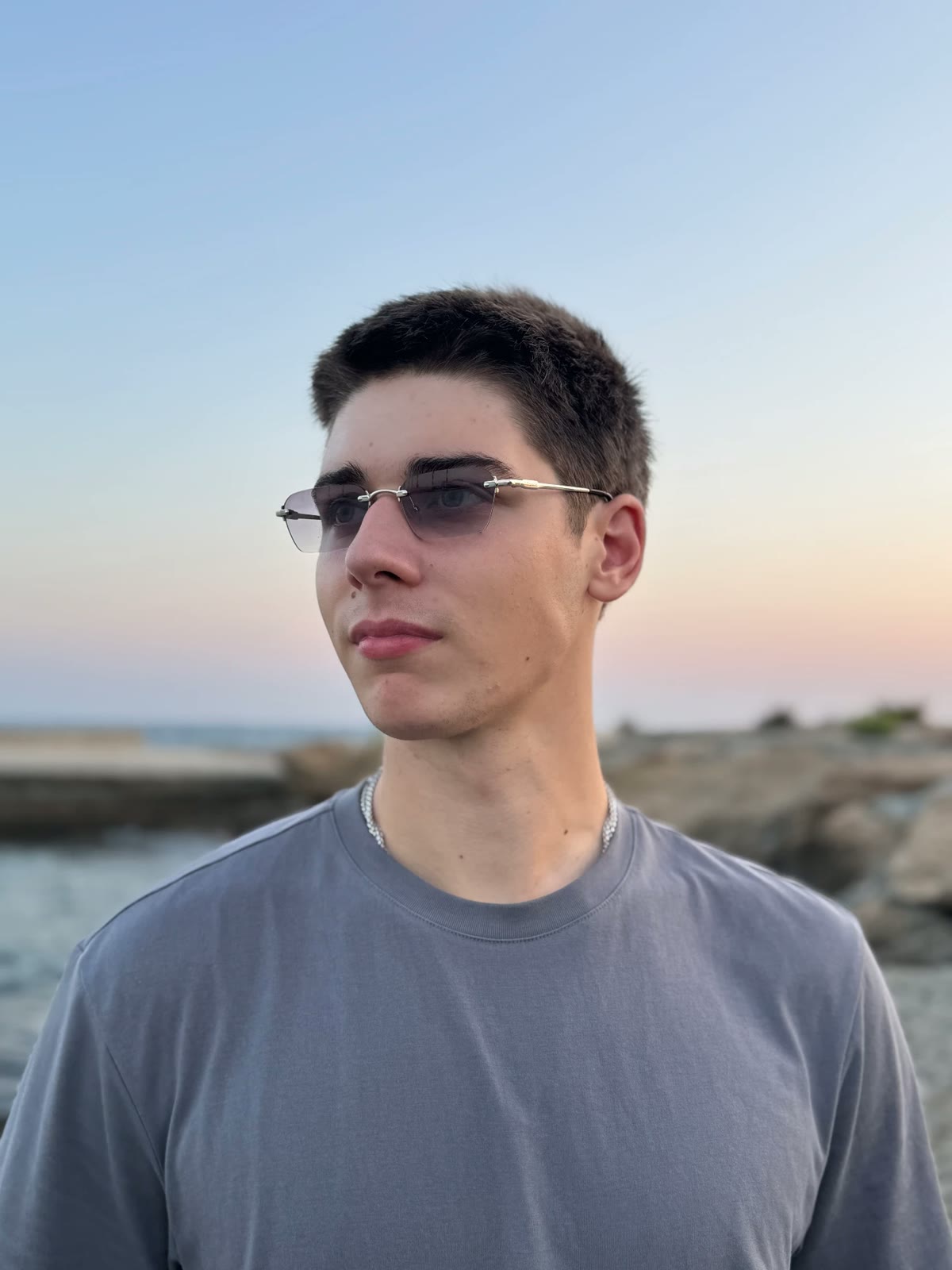 Portrait of Savva, founder of yld., outdoors at sunset in Larnaca